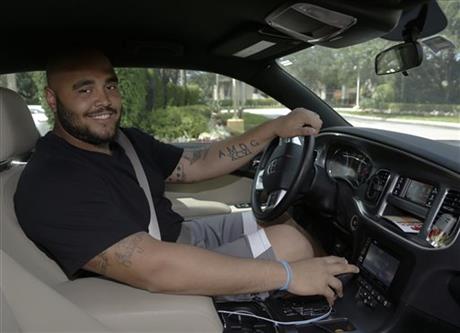 DAVIE, Fla. (AP) — Word on the street is Miami Dolphins reserve defensive tackle A.J. Francis has good acceleration, an excellent motor and a high ceiling in his 2014 Dodge Charger. He's an Uber driver. Francis is under contract to earn $510,000 this year in his third NFL season, but paychecks don't start coming until July, and it's uncertain he'll make the team. He wanted some extra spending money, so in April he became a driver for hire with Uber, making $40 to $50 an hour. "I'm not putting all my eggs in one basket," Francis said following the Dolphins' offseason practice Monday. "Where I'm from, when you have a job, where are you when that job is over?" Team officials have voiced no objection regarding Francis' moonlighting. "Yeah, I was kidding him about Uber or Yuber or whatever you call it," defensive coordinator Kevin Coyle said. "It's a little outside the box, but so is he." The outgoing Francis said the job suits him because he enjoys meeting people. He hopes to pursue a broadcasting career after football, so he polishes his interviewing skills by videotaping conversations with passengers, and posts them on YouTube. "He's a talker," said his wife, Tatiana, who married Francis in March. "He'll talk your ear off about anything." Francis recently finished his third semester studying for a master's degree in international security and economic policy, and he sounds like an economist talking about Uber's impact on the market. "Everywhere Uber is, it thrives," he said. "The resistance comes from taxi drivers who don't want to get beat out, because they know they can't compete. Which is funny to me, because in no other aspect of American culture are you allowed to stifle capitalism." Because of his studies and the Dolphins' offseason training schedule, the flexibility Uber offered was appealing to Francis. He tries to work at least three days a week, in shifts of four to five hours. He said he'll stop driving for pay once training camp starts. NFL veterans who worked in the offseason were common a few decades ago, but in an era when even bottom-of-the-roster players make half a million dollars a year, Francis is a throwback. No Uber rider has recognized the 6-foot-5, 330-pound Francis as a professional football player, which doesn't surprise him. He was undrafted out of the University of Maryland, has spent much of his pro career on practice squads and has yet to play in an NFL game. "People just think I'm some big dude in a nice car," he said. "I tell them at the end of the interview who I am, and the shock on their face is really funny." Tatiana said friends and family are also surprised when they learned of her husband's offseason job. "I admire him for it," she said. "You always have to have a hustle, you know? Football is something that doesn't last forever." Tatiana said Francis is a good driver, and he agreed, saying he has never been ticketed. "Just like I'm a world-class athlete, I'm a world-class driver," he said with a grin. "If I wasn't 330, Tony Stewart should watch out." Uber jobs have taken Francis from Boca Raton to South Beach, and he has waited in vain for the chance to drive someone to another state. He would love more time to chat up a passenger. He has given lifts to a couple of his teammates, and has been teased by most of them. Pro Bowl defensive end Cameron Wake said he has yet to hire Francis as a driver. "I have a car, so I probably wouldn't," Wake said. "But I can't knock anybody's hustle. He's an interesting guy." Coach Joe Philbin said he would recommend Francis to anyone in need of a ride. "Definitely," Philbin said with a smile. "But I would suggest that they bring some earplugs along."